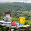 on picnic table with hills behind, regular 135g size shown