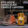 UCO Candlelier Candle Lantern lit next to a pair of boots.