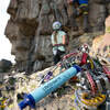 on ground next to carabiners, climbers in background